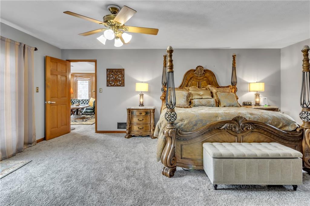 838 Conyers Road McDonough, GA 30252 - Photo 28 of 31 a bedroom with a bed and a chandelier