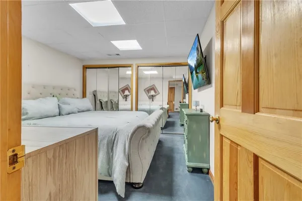 a spacious bedroom with a bed and a large window