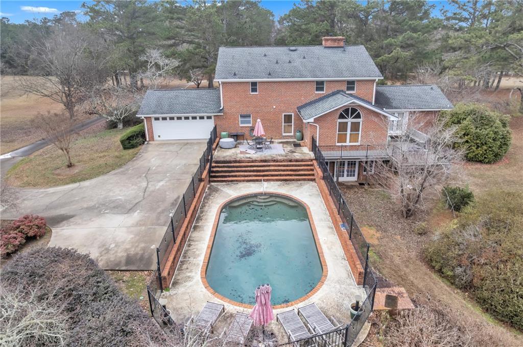 838 Conyers Road McDonough, GA 30252 - Photo 3 of 31 an aerial view of a house with swimming pool