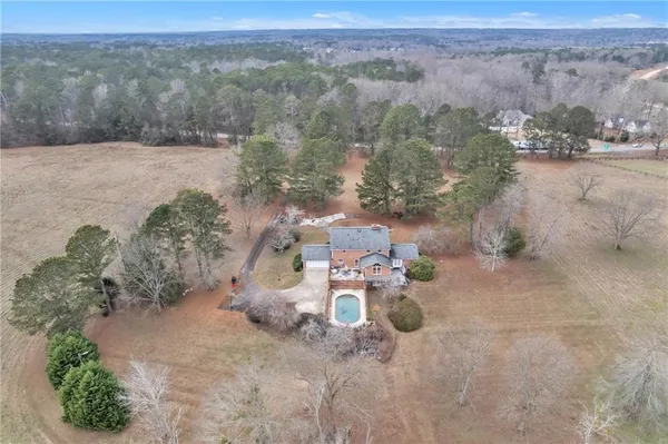 an aerial view of a house with yard
