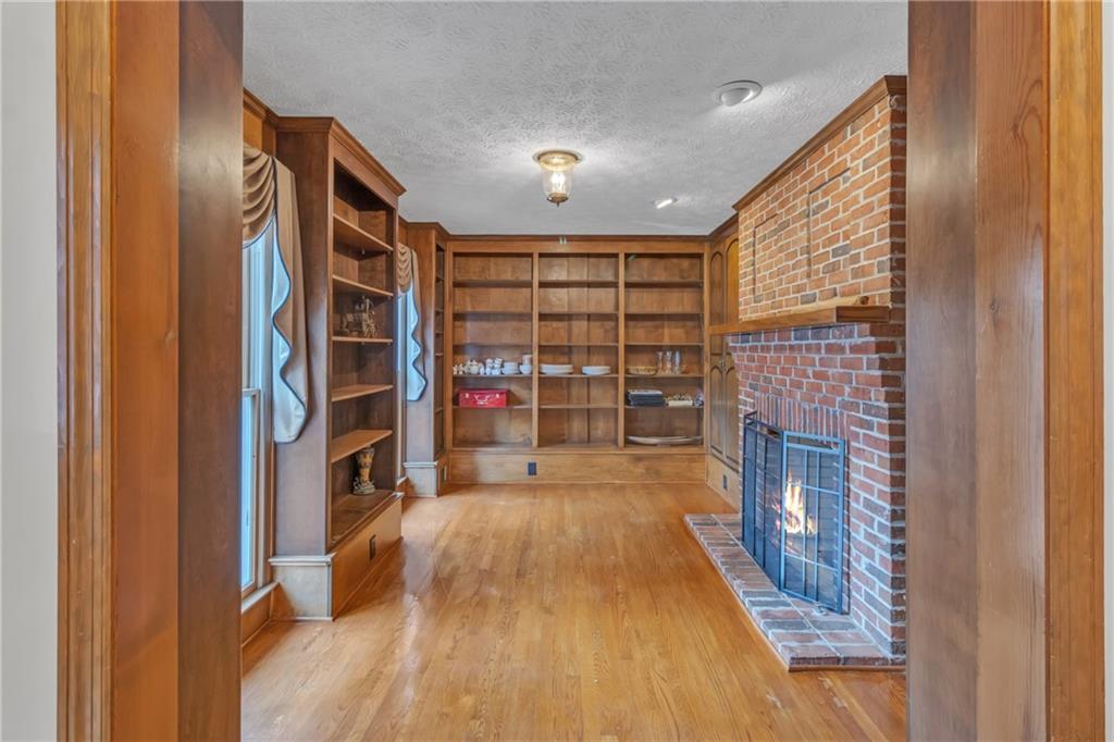 838 Conyers Road McDonough, GA 30252 - Photo 6 of 31 a furnished livingroom with a fireplace and a book shelf