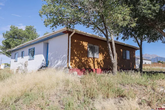 a kitchen with stainless steel appliances a sink a stove a refrigerator cabinets and a window