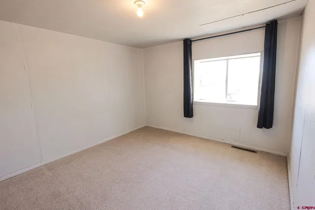 a view of a livingroom with furniture and windows