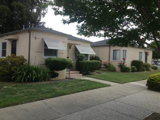 Cream color duplex, a 1 bed on one side and a 2 bed on the other side.