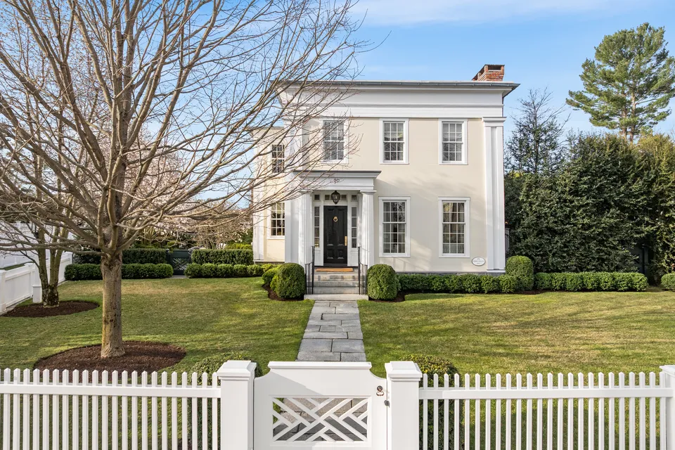 White house with tree and green lawn