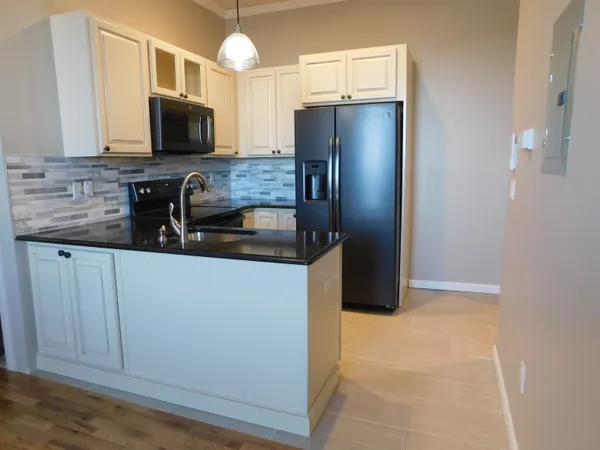 a kitchen with stainless steel appliances a refrigerator a stove a microwave and cabinets