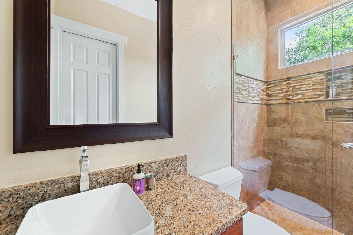 2800 Waymaker Way, Unit 63 Austin, TX 78746 - Photo 14 of 36 a bathroom with a sink and a mirror