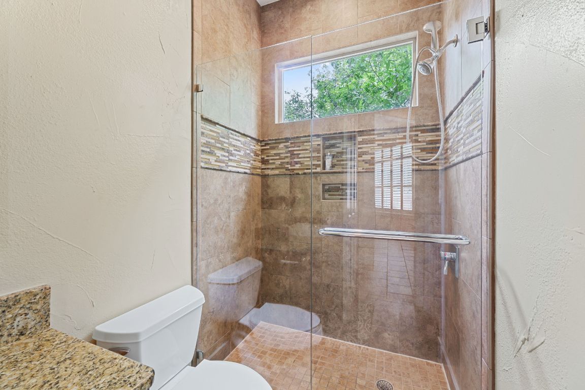 2800 Waymaker Way, Unit 63 Austin, TX 78746 - Photo 16 of 36 a bathroom with a toilet and a shower