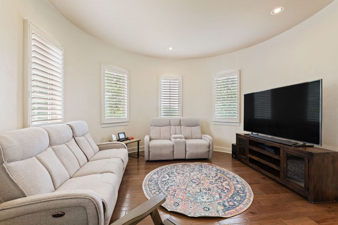 2800 Waymaker Way, Unit 63 Austin, TX 78746 - Photo 17 of 36 a living room with furniture and a flat screen tv