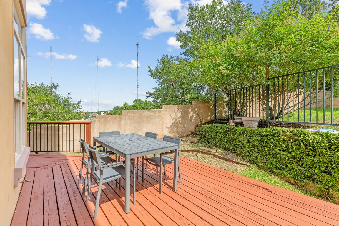 2800 Waymaker Way, Unit 63 Austin, TX 78746 - Photo 22 of 36 a balcony with wooden floor table and chairs