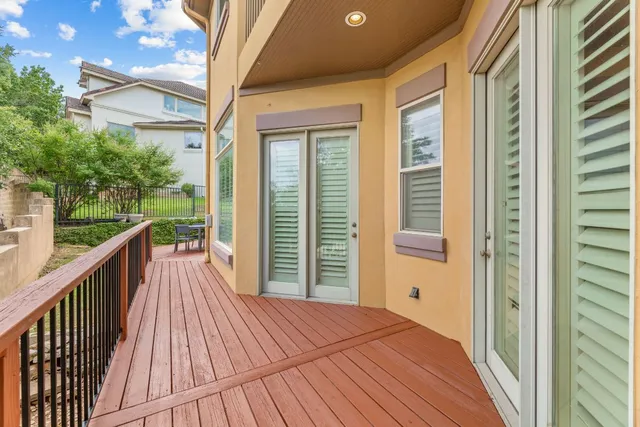 a view of a deck with table and chairs with wooden floor and fence