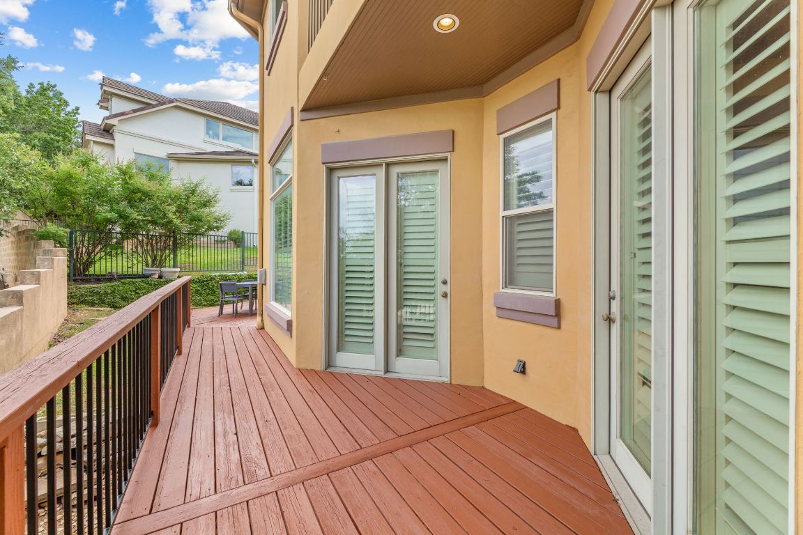 2800 Waymaker Way, Unit 63 Austin, TX 78746 - Photo 24 of 36 a view of a balcony with wooden floor and fence