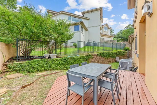 a view of a balcony with wooden floor and fence
