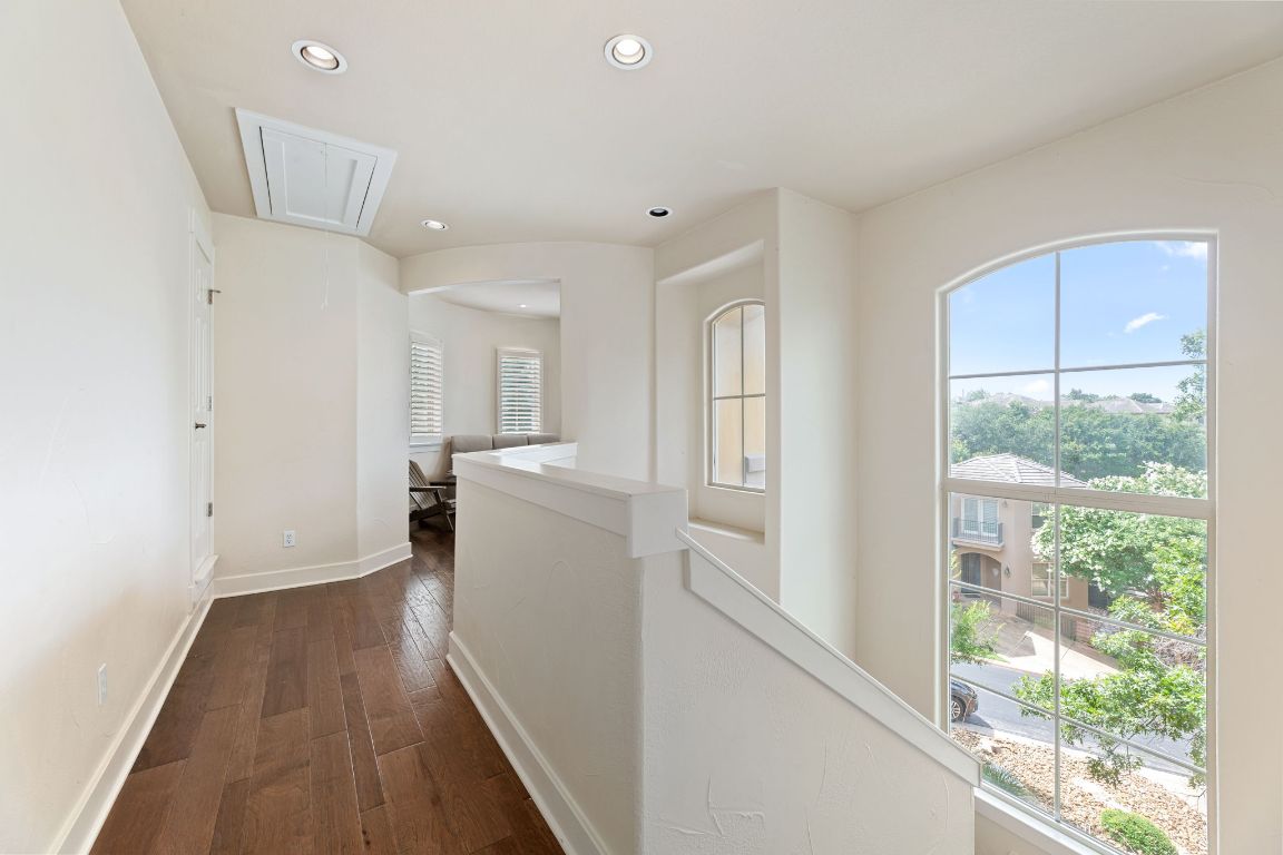 2800 Waymaker Way, Unit 63 Austin, TX 78746 - Photo 6 of 36 a view of a kitchen with wooden floor and electronic appliances