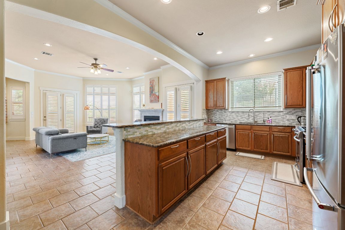 2800 Waymaker Way, Unit 63 Austin, TX 78746 - Photo 36 of 36 a large kitchen with stainless steel appliances granite countertop a stove and a sink