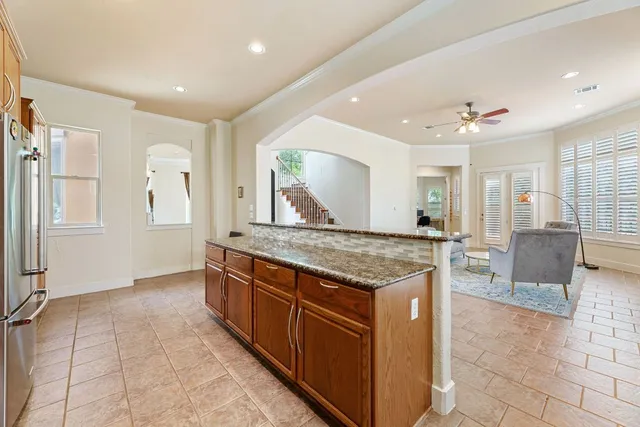 a kitchen with stainless steel appliances granite countertop a sink stove and cabinets