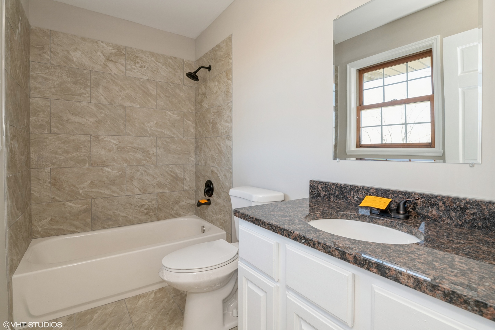 4818 5th Street Winthrop Harbor, IL 60096 - Photo 14 of 17 a bathroom with a granite countertop sink a toilet and bathtub