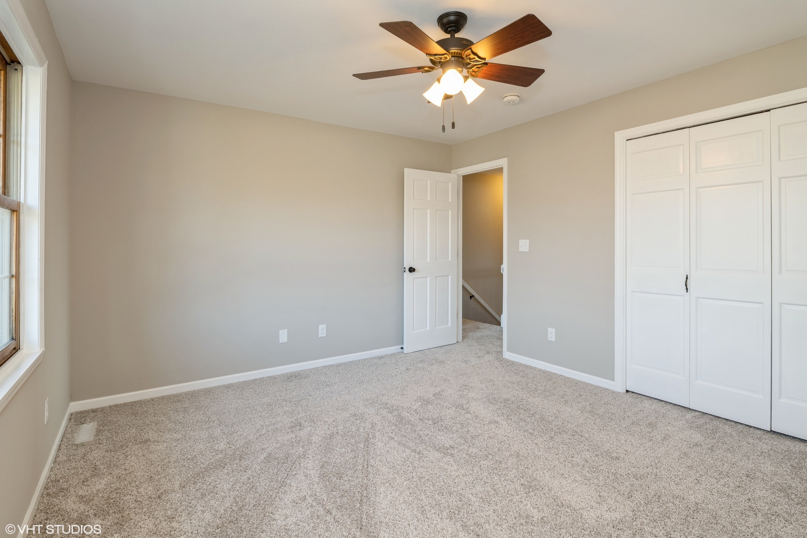 4818 5th Street Winthrop Harbor, IL 60096 - Photo 15 of 17 an empty room with chandelier fan and windows