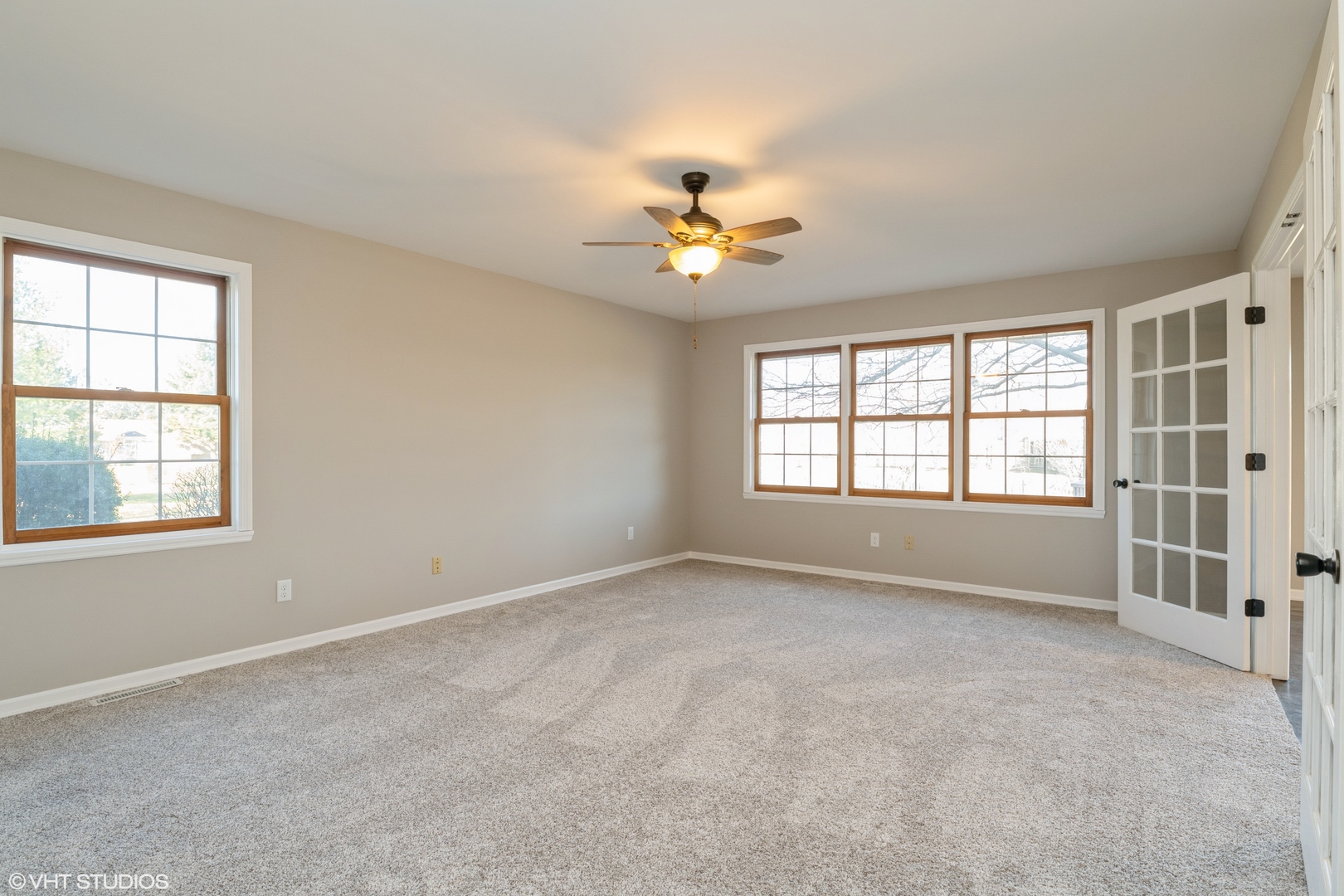 4818 5th Street Winthrop Harbor, IL 60096 - Photo 6 of 17 an empty room with chandelier fan and windows