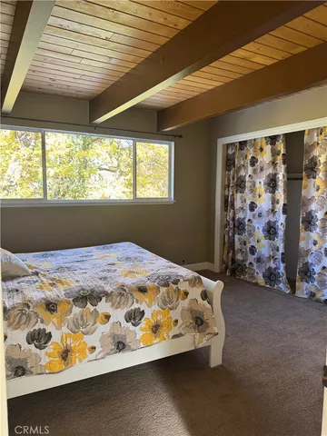 a bed sitting in a bedroom next to a window
