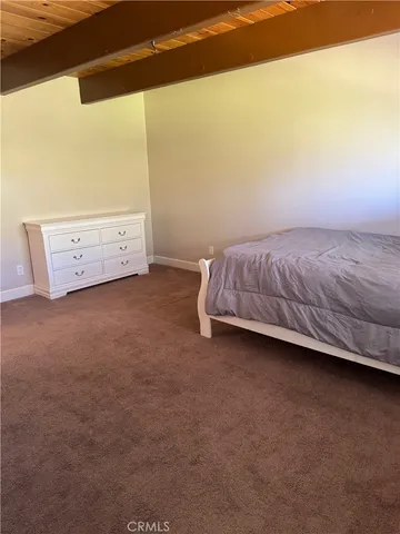 a bed sitting in a room next to a window