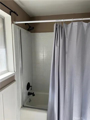 a bathroom with a shower and a tub