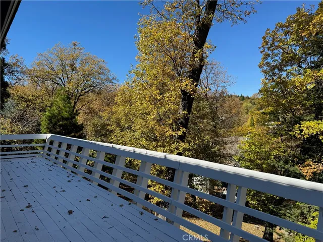 a view of a balcony with wooden fence