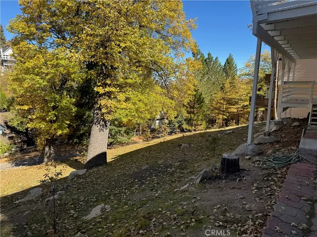 a view of a yard with wooden fence