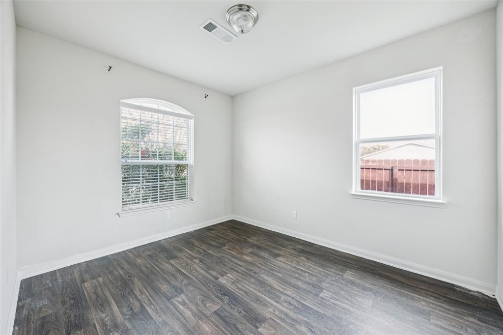 1020 Walnut Ridge Drive Hutchins, TX 75141 - Photo 12 of 28 an empty room with wooden floor and windows