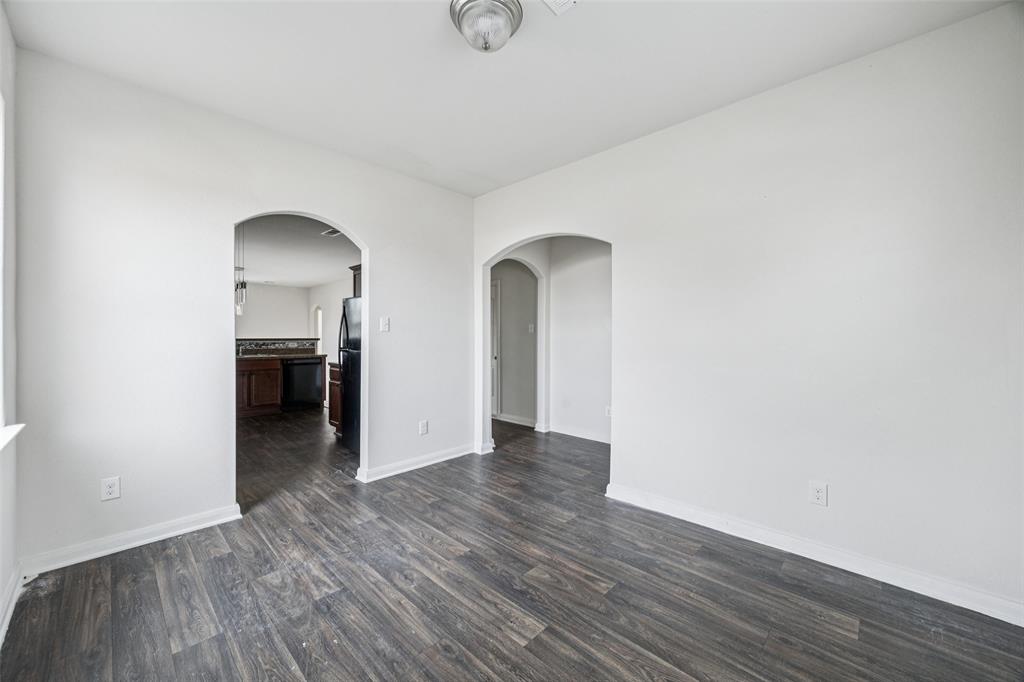 1020 Walnut Ridge Drive Hutchins, TX 75141 - Photo 13 of 28 an empty room with wooden floor and a window