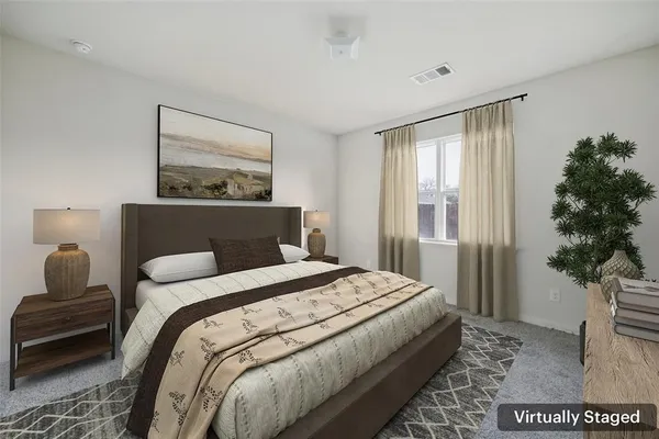 a bedroom with a bed and a couch