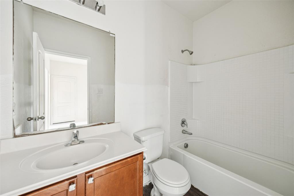 1020 Walnut Ridge Drive Hutchins, TX 75141 - Photo 21 of 28 a bathroom with a sink a toilet and shower