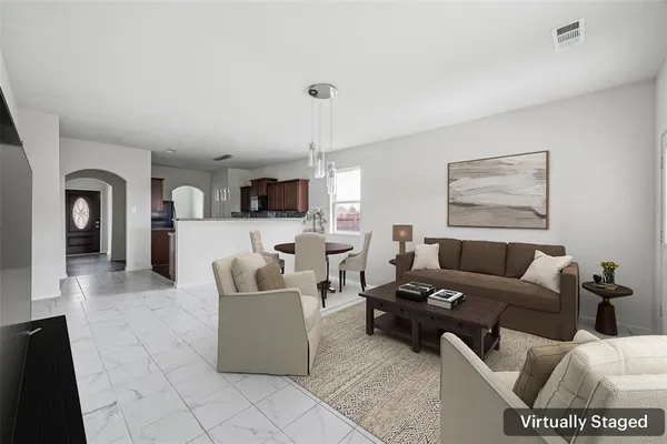 a living room with furniture and kitchen view