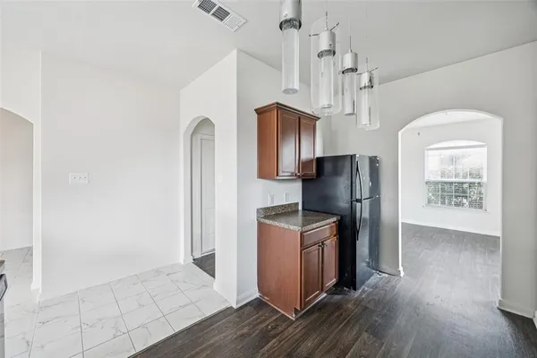 a view of kitchen with stainless steel appliances granite countertop cabinets and wooden floor