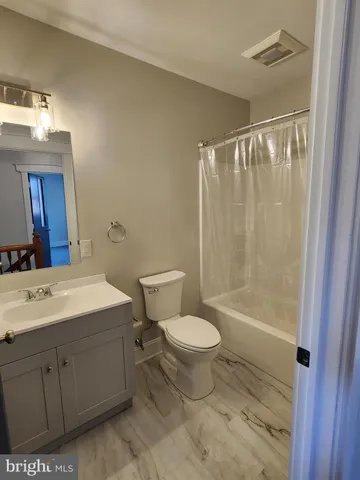 a bathroom with a sink toilet a mirror and shower