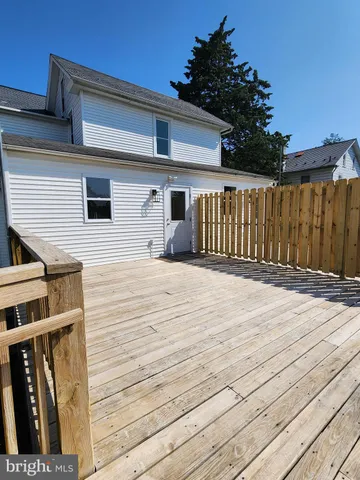 a view of a house with wooden deck