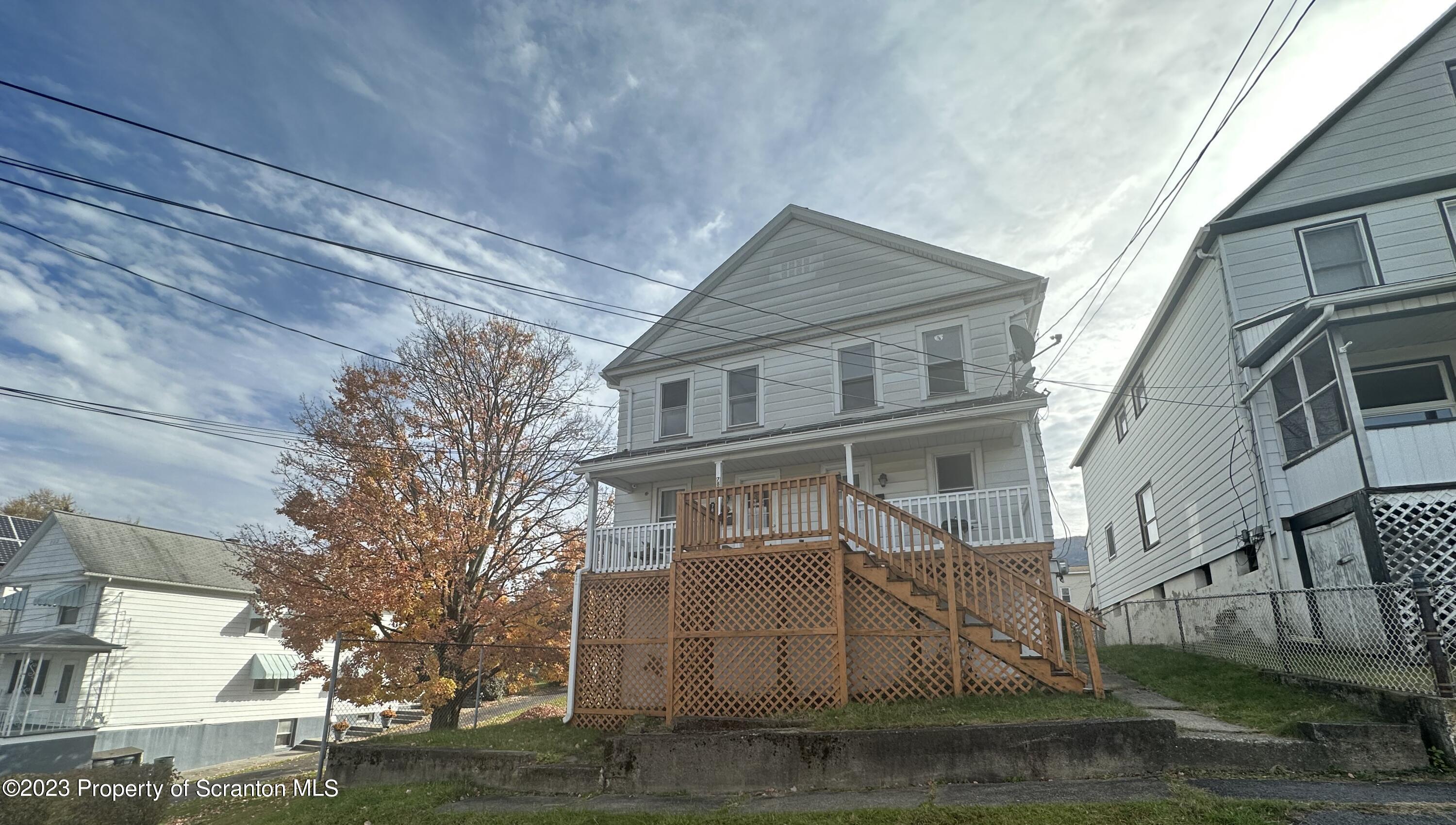 a view of a white house with large windows