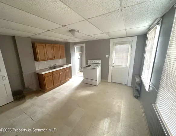 a view of a kitchen with a sink dishwasher and a fireplace
