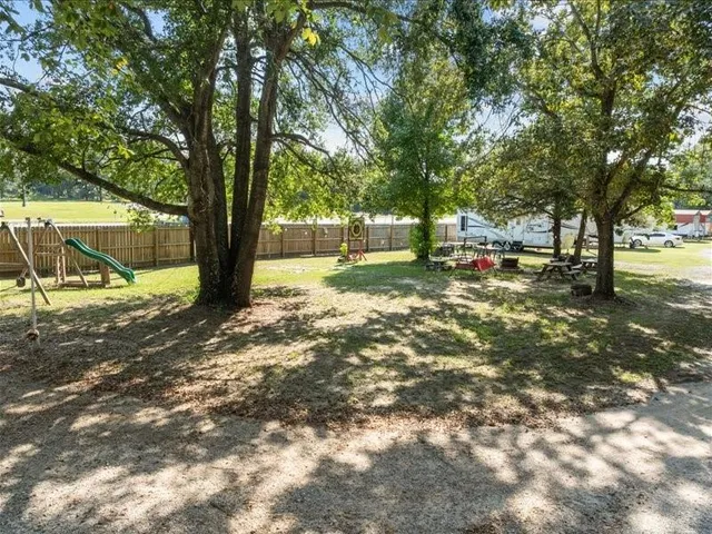 a view of a house with a yard and potted plants