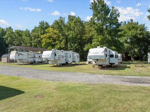 a view of a yard with cars