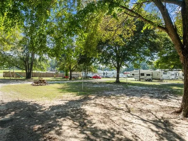 a wooden bench sitting in front of building