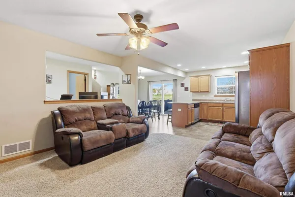 a living room with furniture and kitchen view
