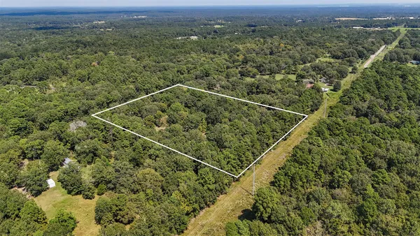a view of a balcony with a forest