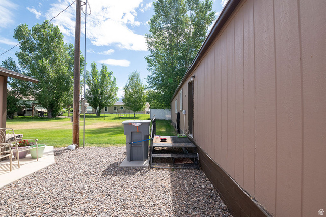 855 East 300 N Street Beaver, UT 84713 - Photo 14 of 44 Light brown vertical siding with dark brown trim and a dark brown foundation