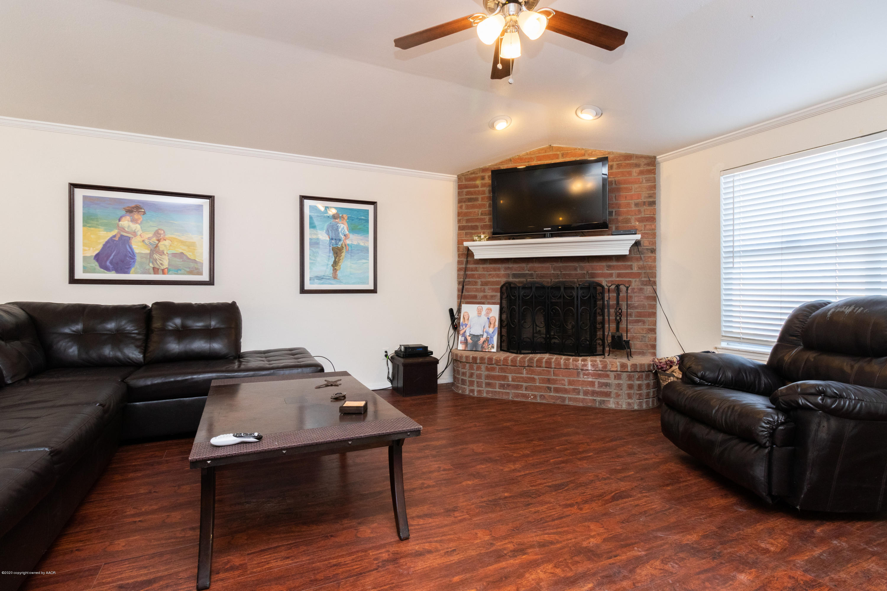 5203 Capulin Lane Amarillo, TX 79110 - Photo 11 of 29 a living room with furniture and a flat screen tv