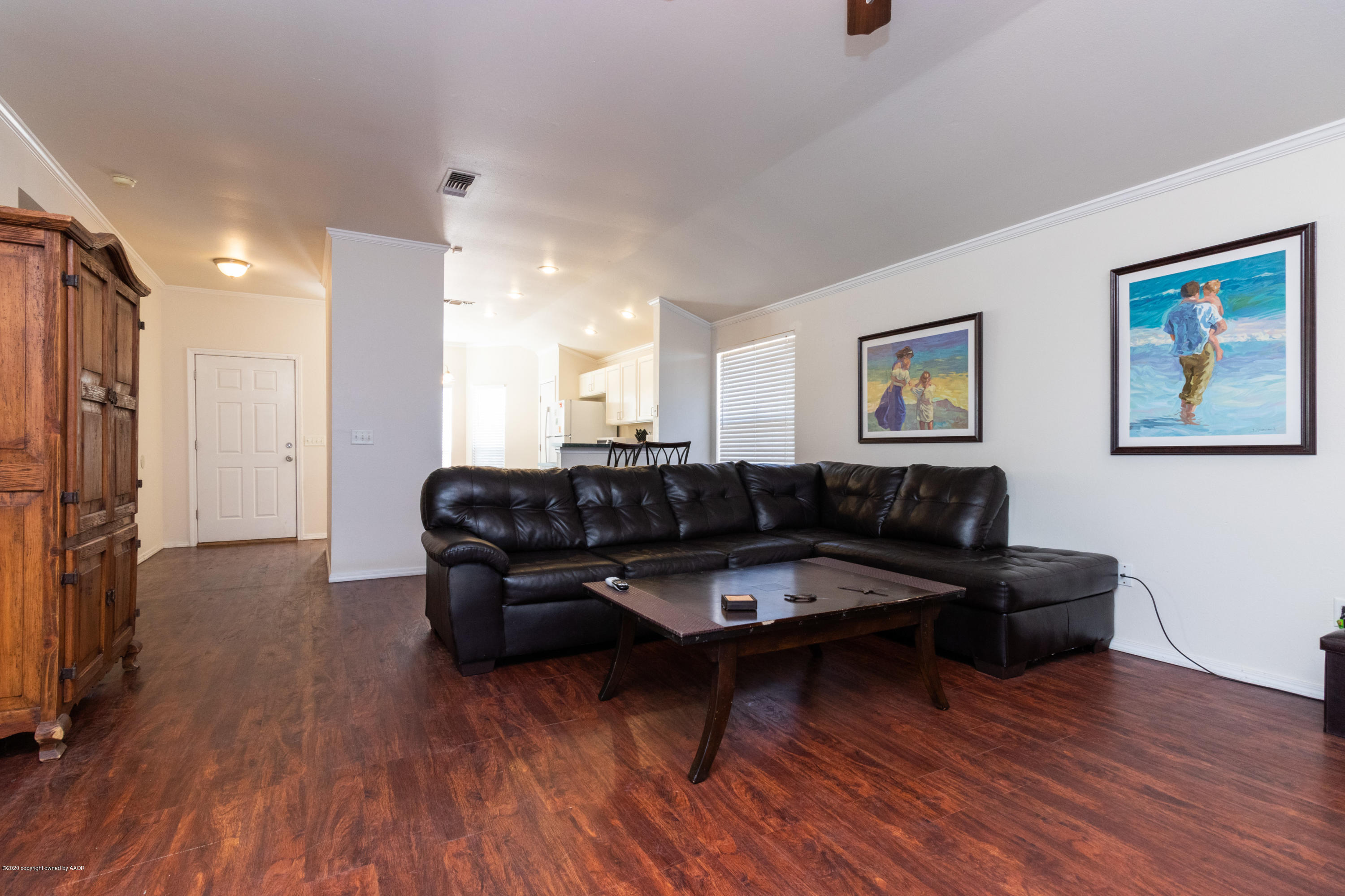 5203 Capulin Lane Amarillo, TX 79110 - Photo 12 of 29 a living room with furniture and a wooden floor