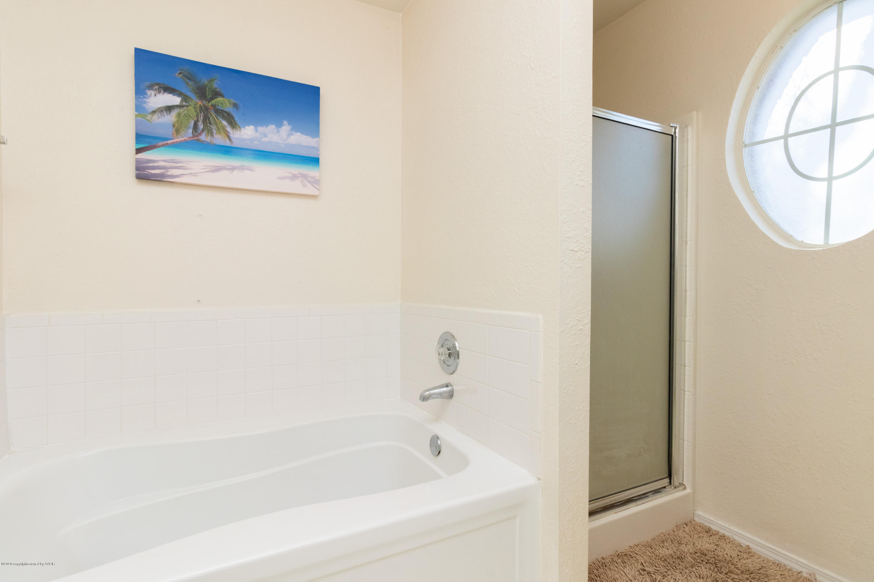 5203 Capulin Lane Amarillo, TX 79110 - Photo 19 of 29 a white bath tub sitting next to a shower