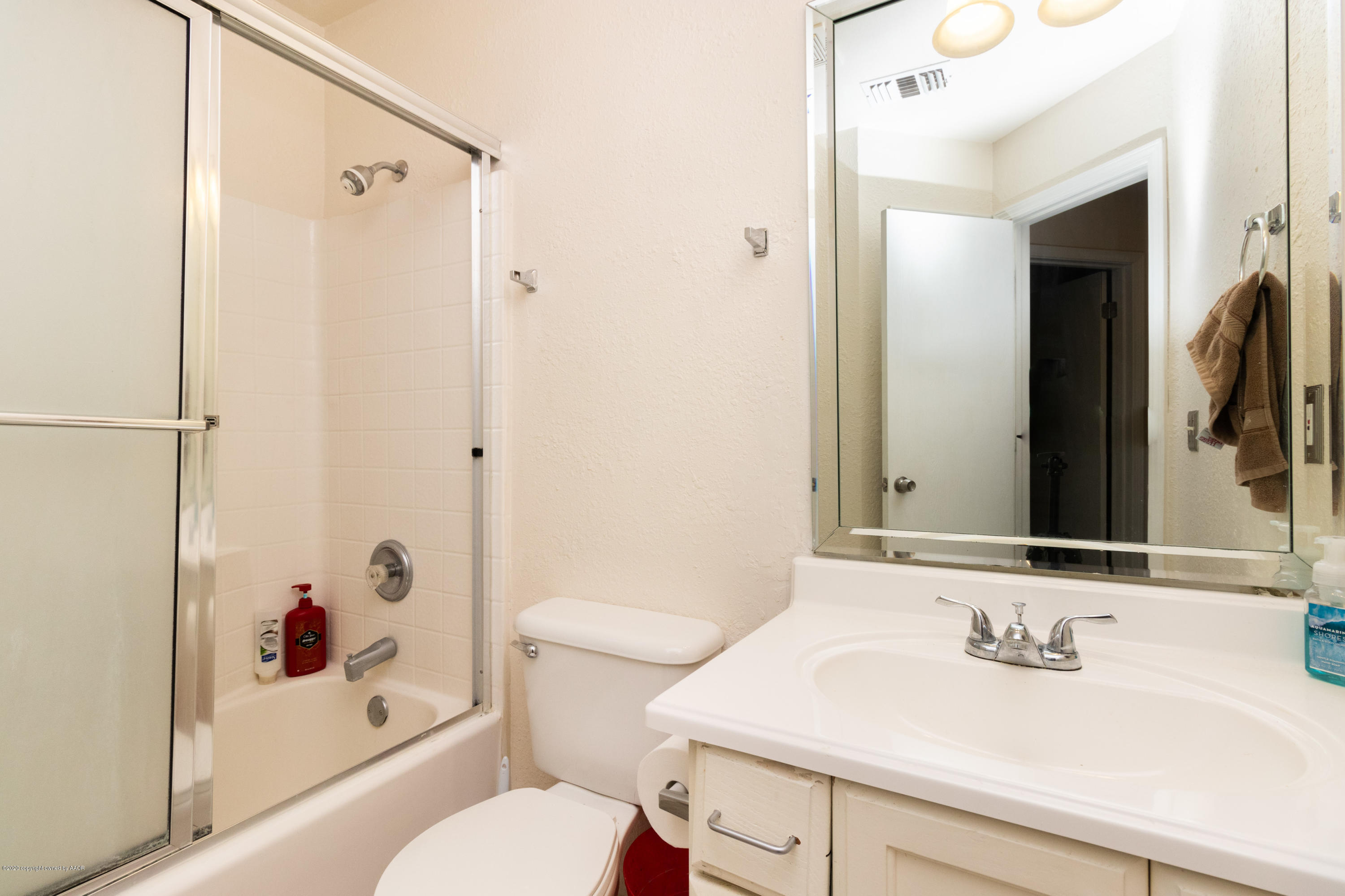 5203 Capulin Lane Amarillo, TX 79110 - Photo 22 of 29 a bathroom with a sink toilet and shower