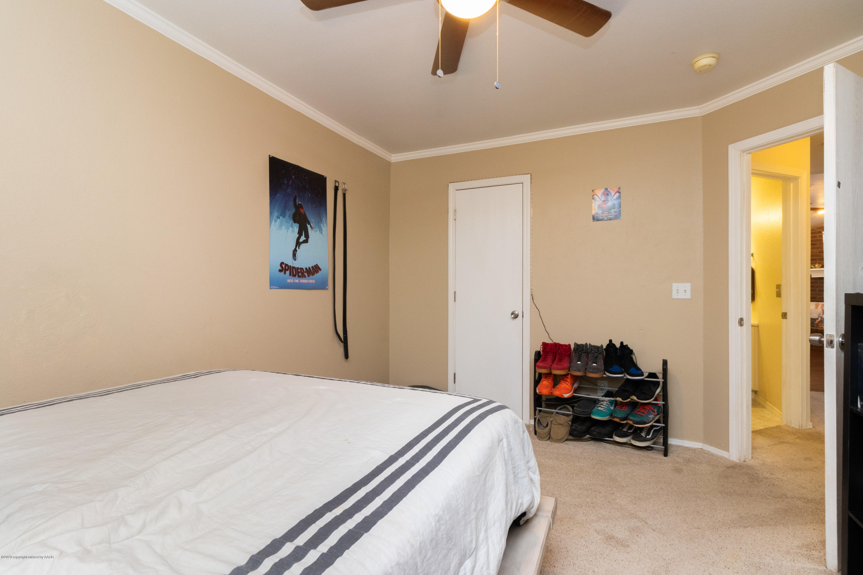 5203 Capulin Lane Amarillo, TX 79110 - Photo 24 of 29 a bedroom with a bed and a chandelier