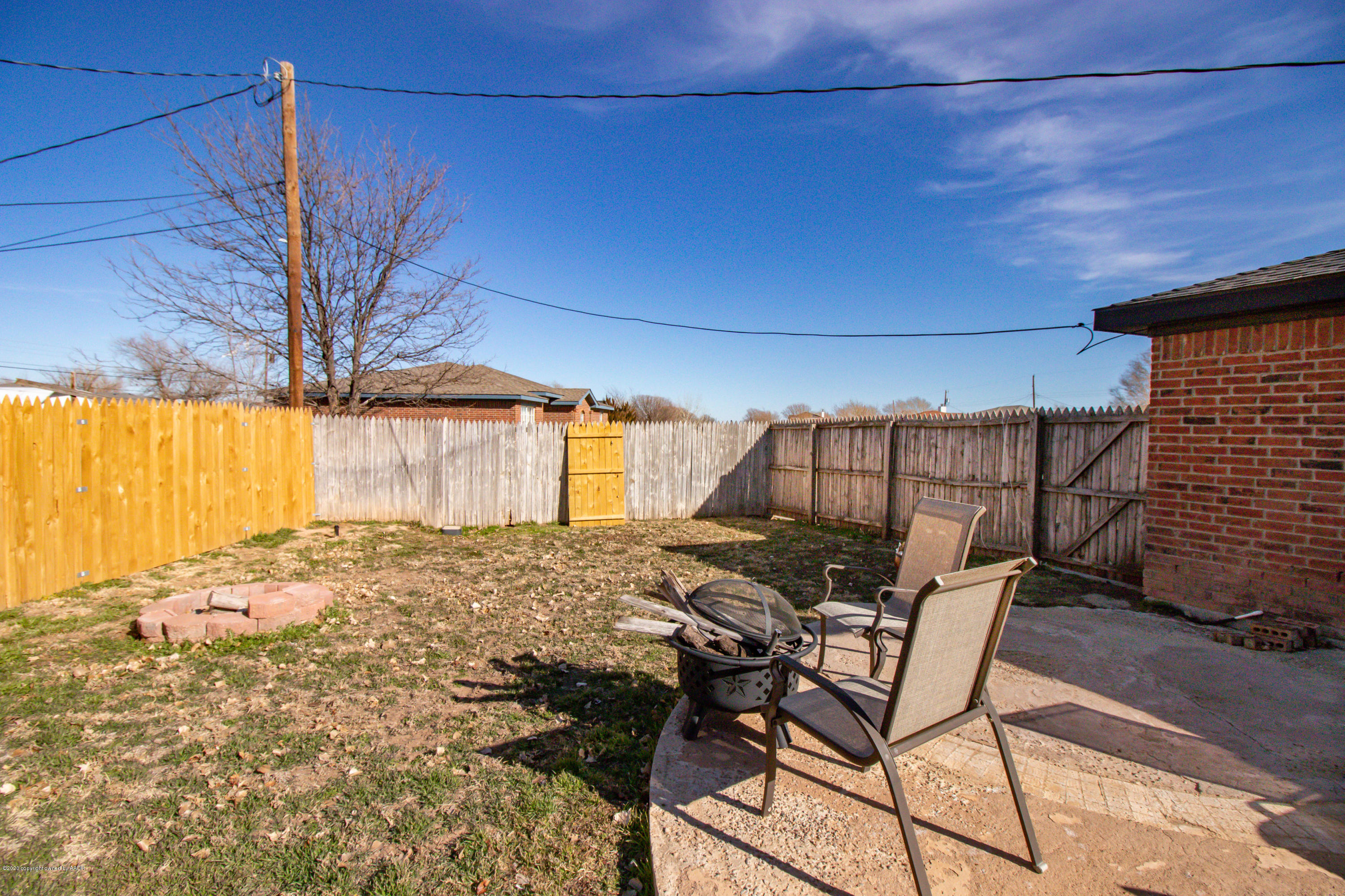 5203 Capulin Lane Amarillo, TX 79110 - Photo 27 of 29 a view of a backyard with table and chairs and wooden fence
